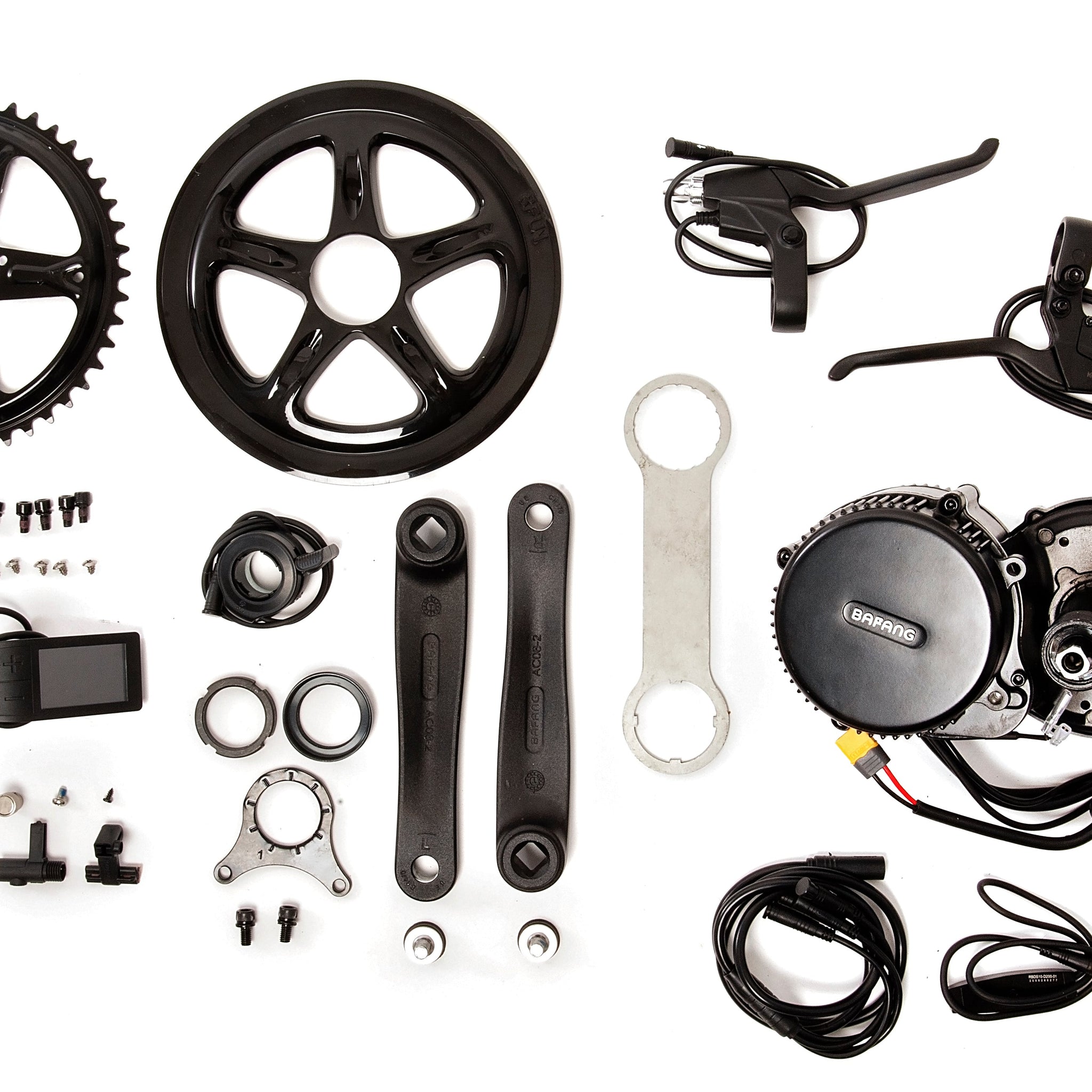 Bafang BBS02 mid drive motor parts and tools for eBike conversion kit laid out on white background